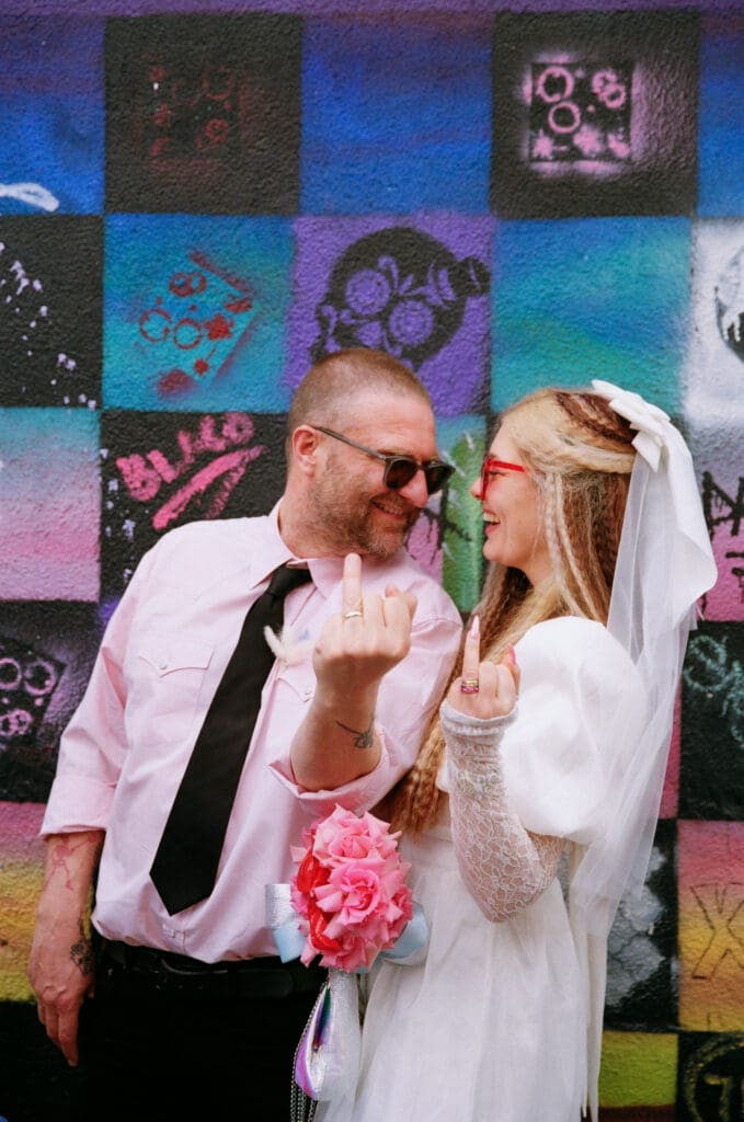 fun picture of the newlyweds showing their wedding rings
