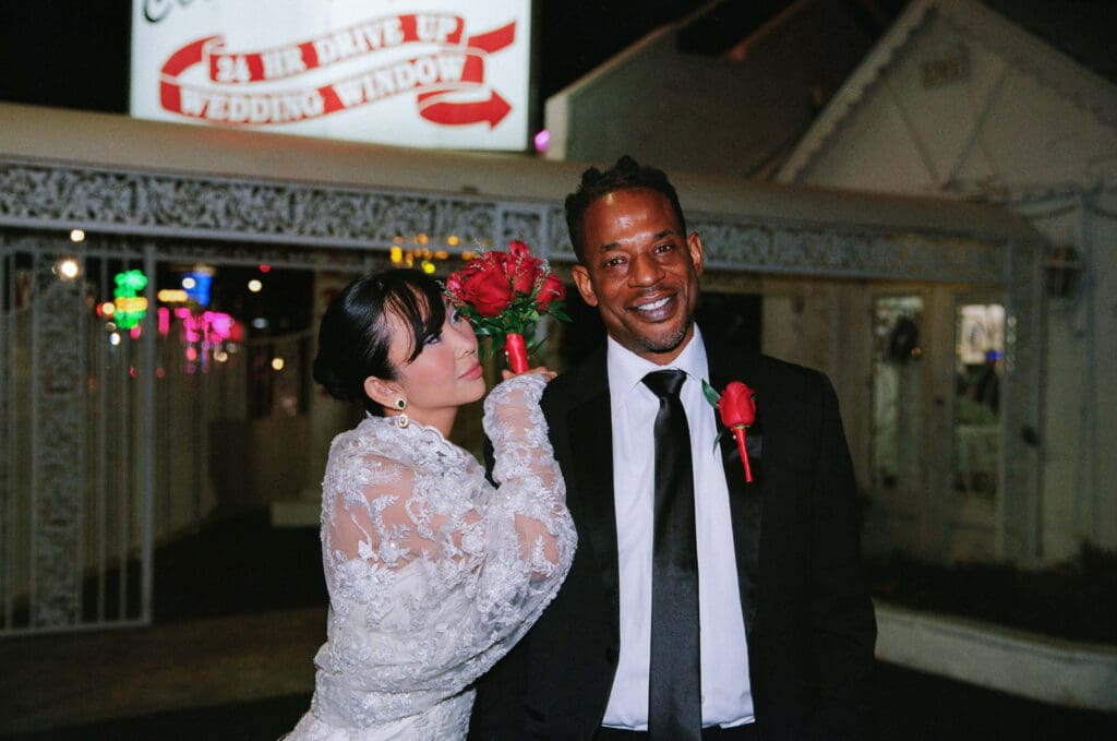 portrait of the bride looking and smiling with the groom