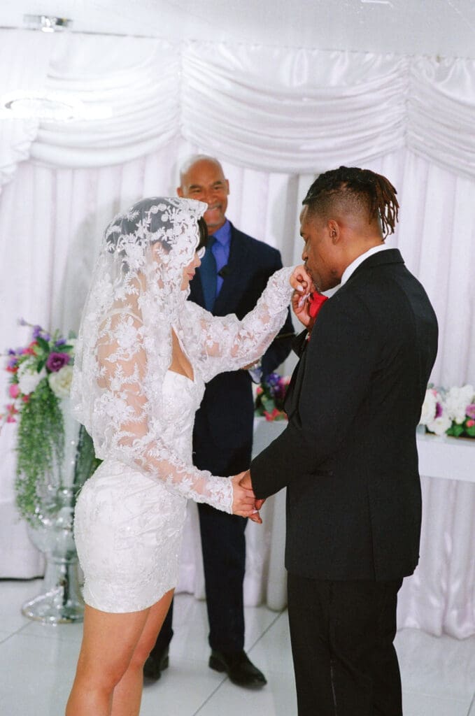 groom kissing the brides hand during their elopement