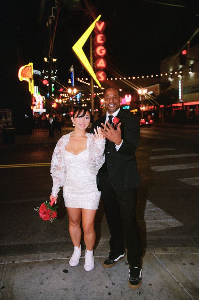 fun picture of the newlyweds showing their wedding rings