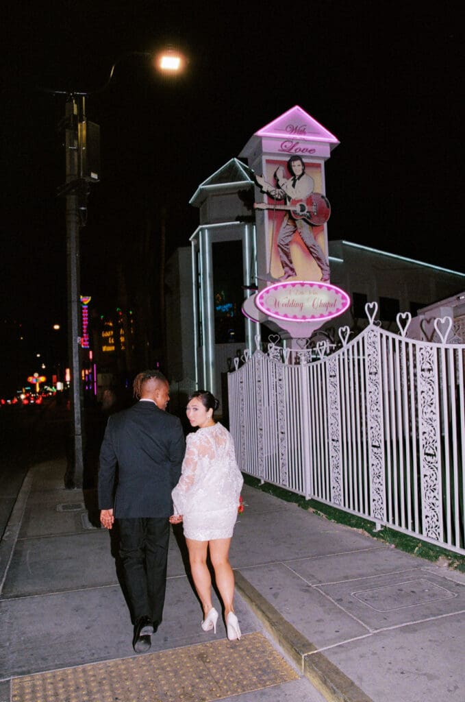 couple holding hands walking around fremont street