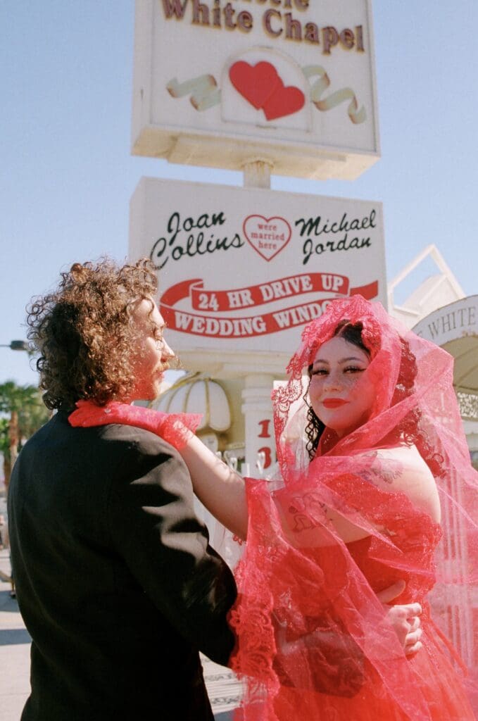 cute couple kissing outside of their little white wedding chapel elopement
