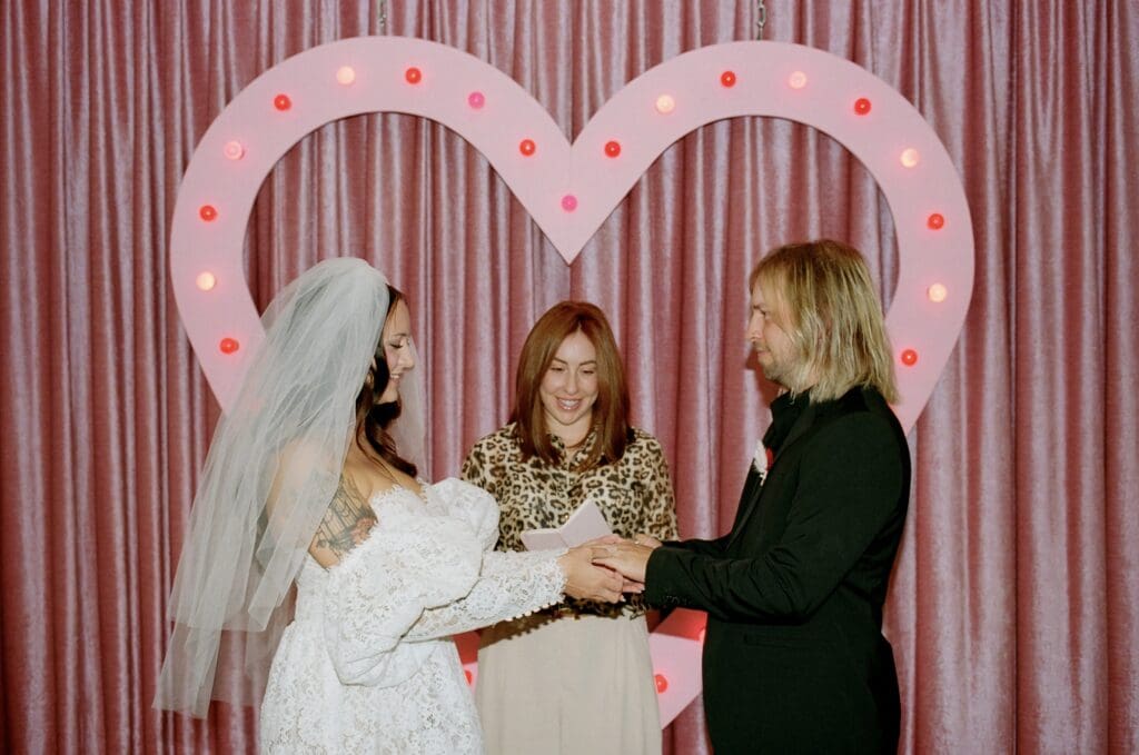 cute portrait of the bride and groom holding hands at their ceremony
