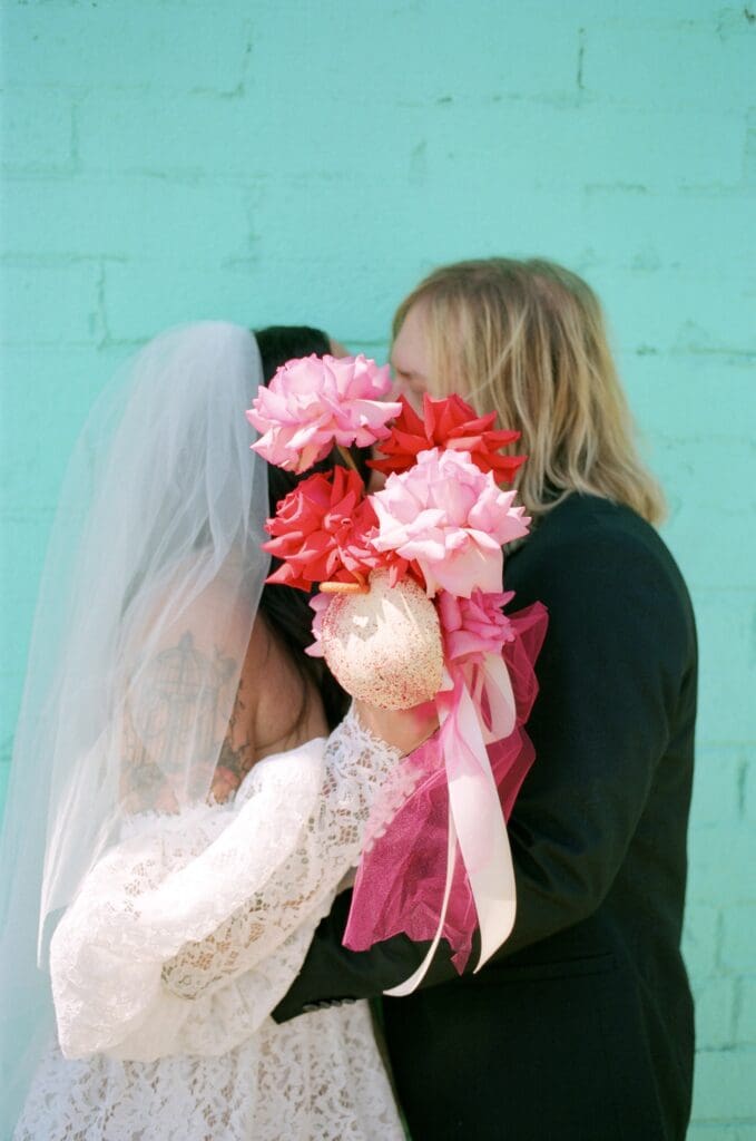portrait of the newlyweds kissing during their photoshoot