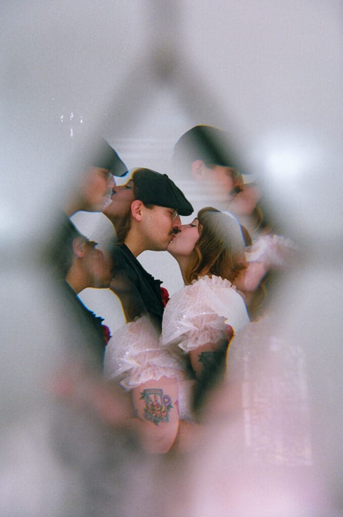 cute picture of the newly married couple kissing 