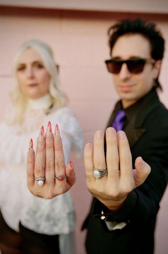 picture of the couple showing their wedding rings