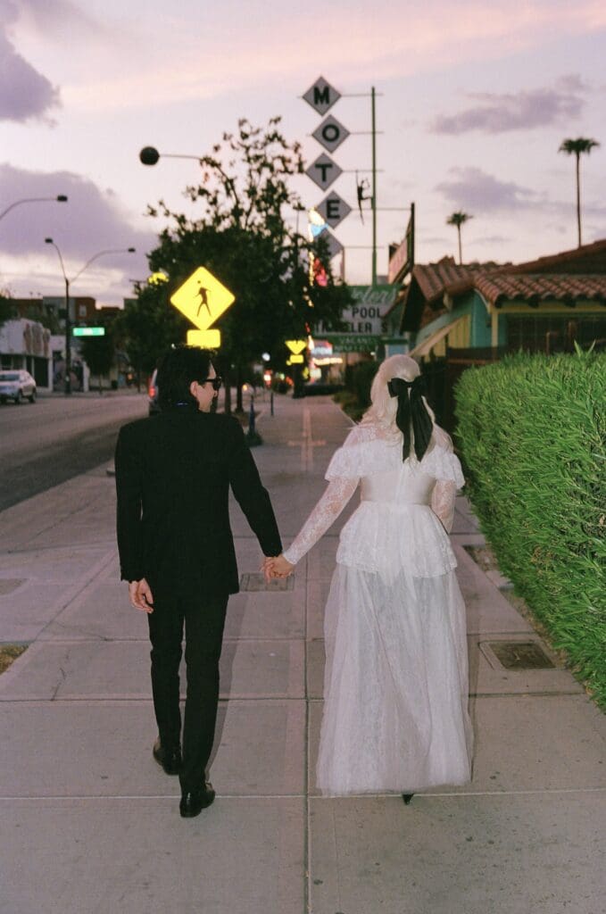 cute couple holding hands walking around downtown fremont street