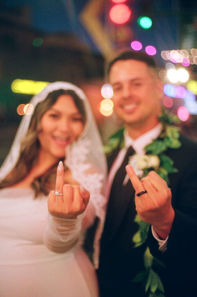 fun picture of the newlyweds showing their wedding rings