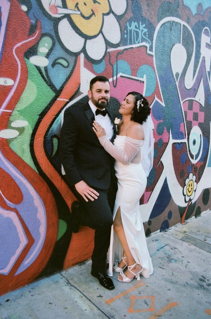 Bride and groom, laughing with each other during their photoshoot