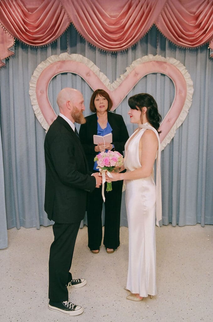 Bride and groom holding hands during their ceremony