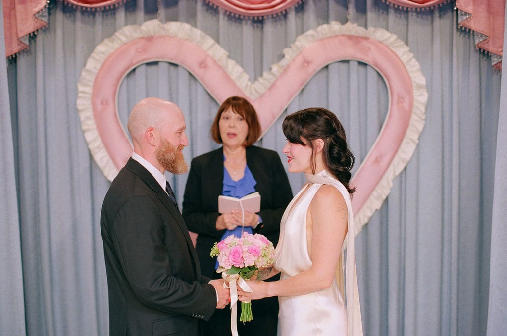 cute picture of the bride and groom, holding hands during their ceremony
