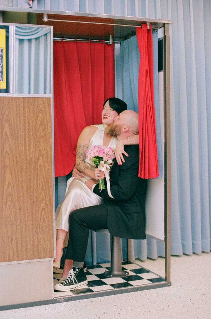 Groom, kissing the bride on the cheek