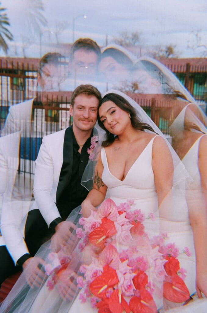 cute picture of the newlyweds smiling at the camera during their photoshoot