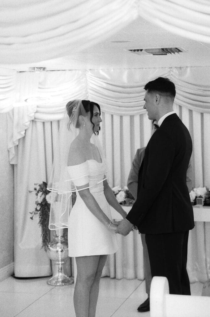 bride and groom holding hands during their ceremony
