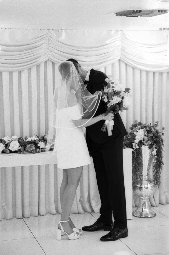 bride and groom kissing after their ceremony