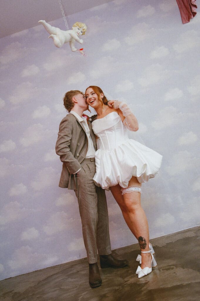 groom kissing the bride on the cheek