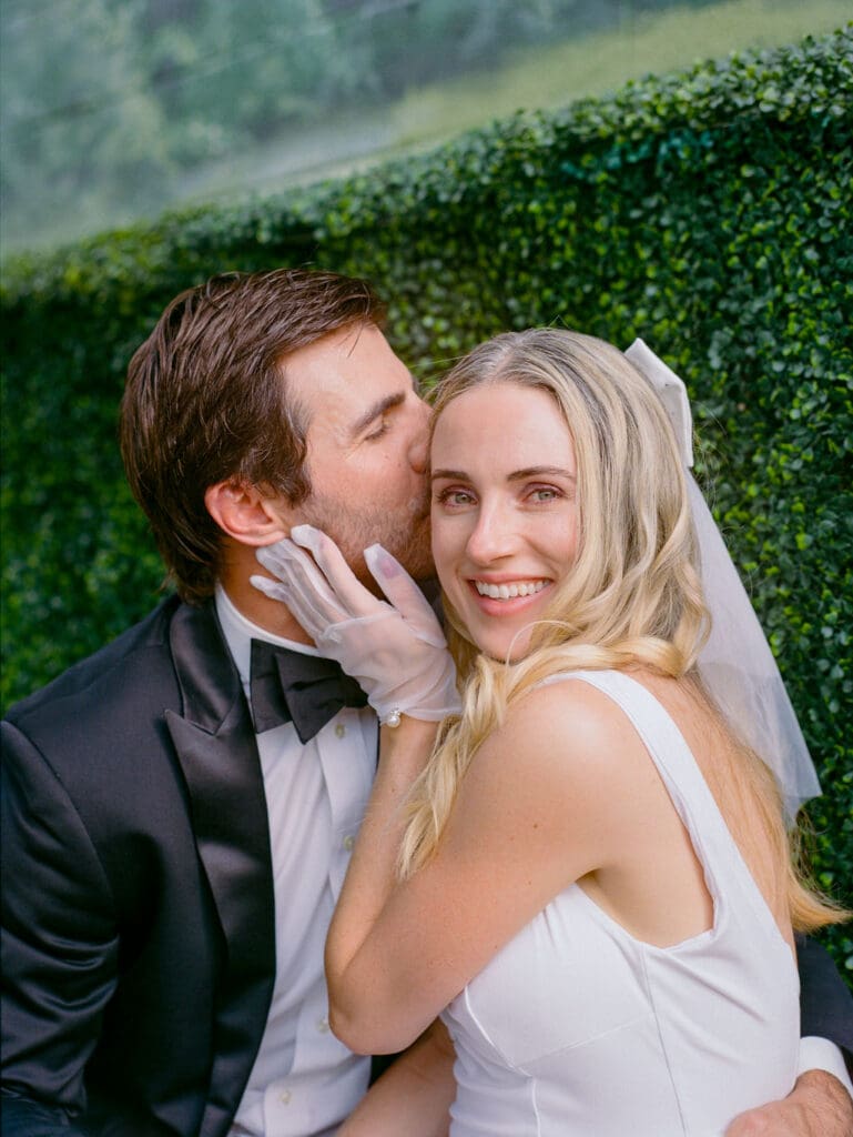 groom kissing the bride on the forehead