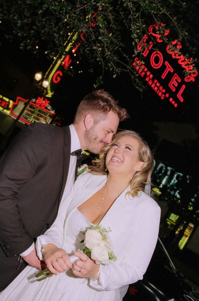 groom kissing the bride on the cheek