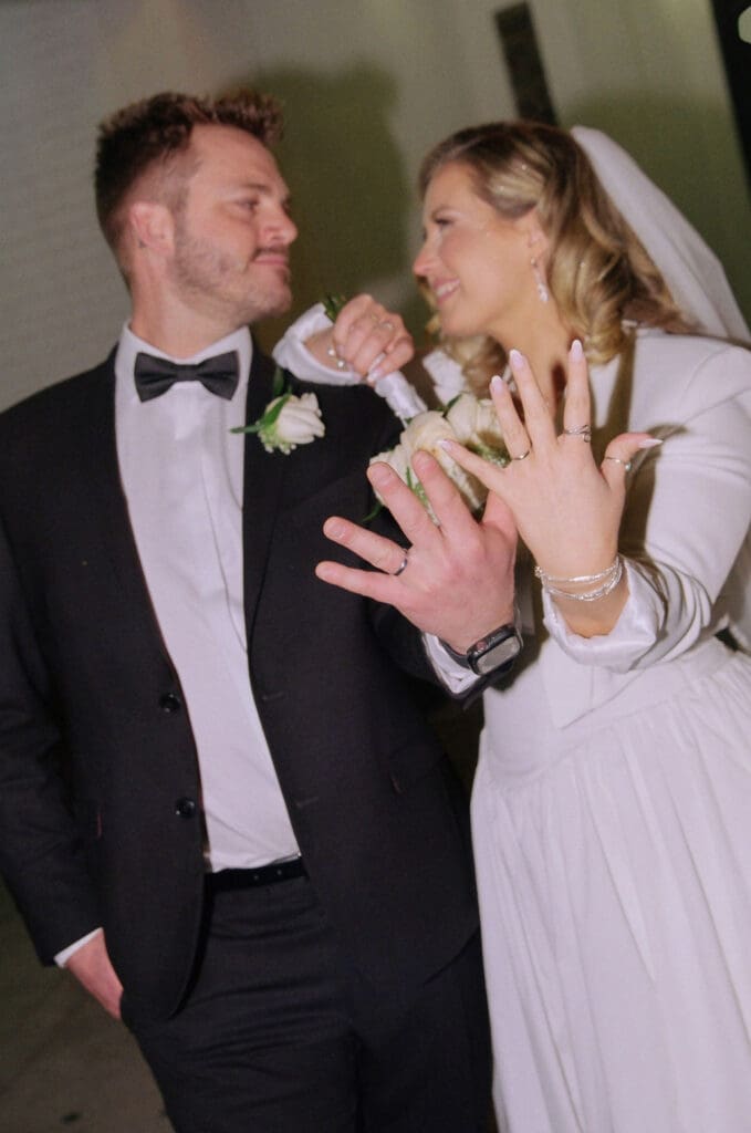 picture of the newlyweds showing their wedding rings