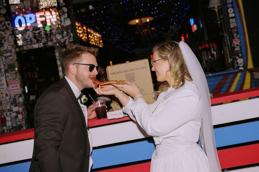 couple celebrating their elopement with pizza