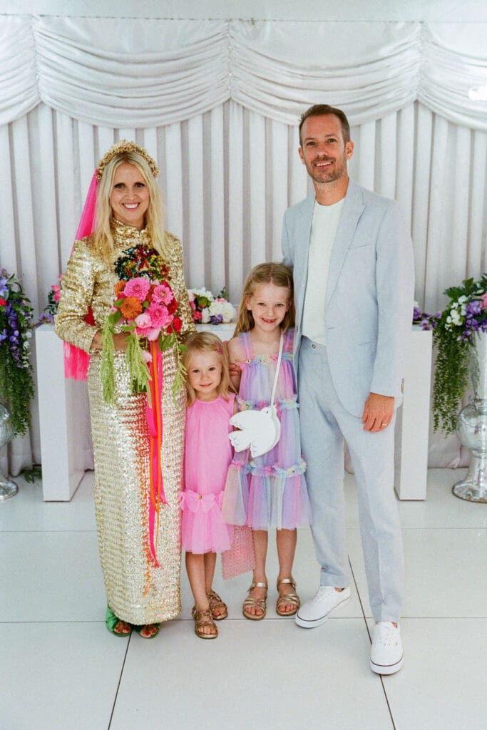 cute picture of the bride and groom with their daughters
