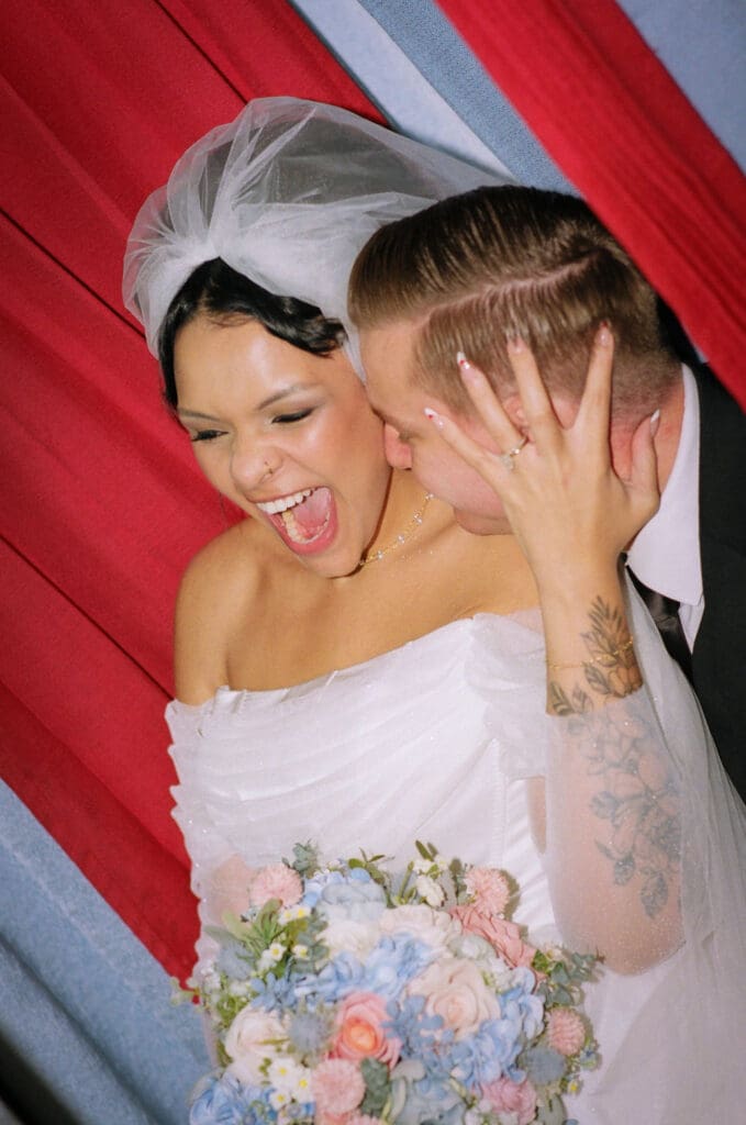 groom kissing the bride on the cheek