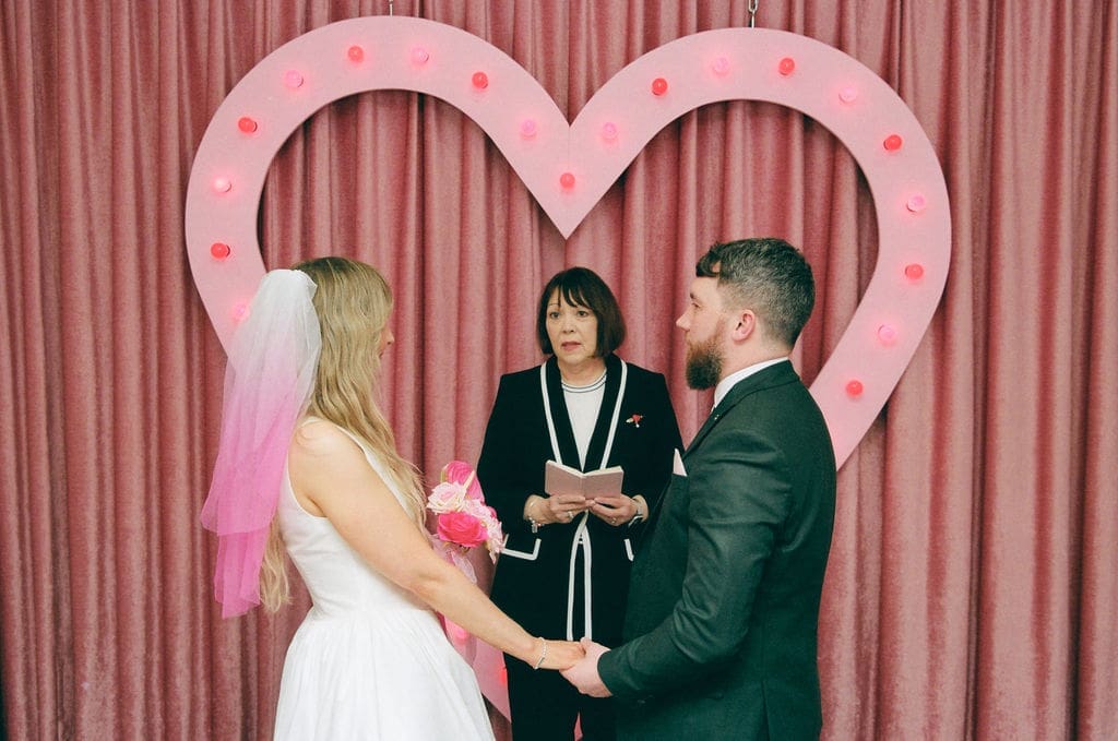 Bride and groom holding hands during their wedding ceremony