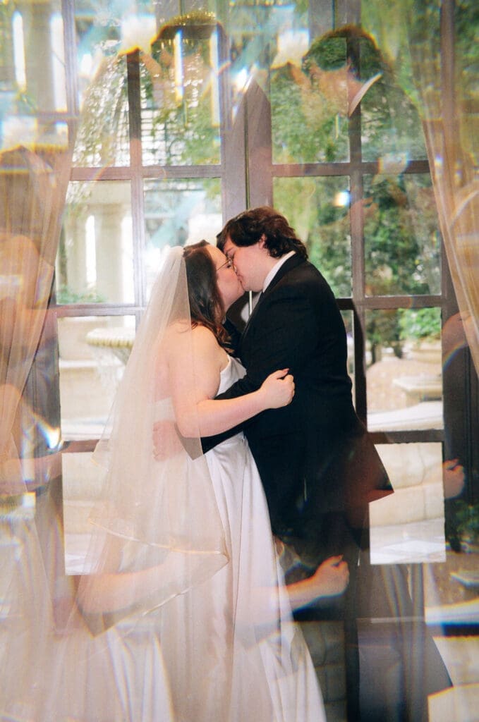 portrait of the newlyweds kissing after their ceremony
