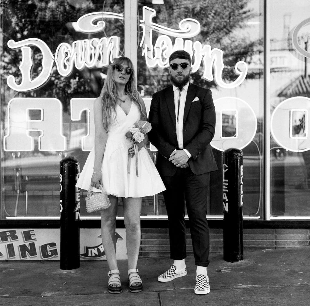 bride and groom smiling at the camera during their photoshoot