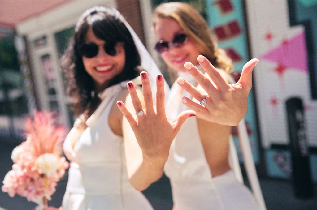 couple showing their wedding rings after their ceremony