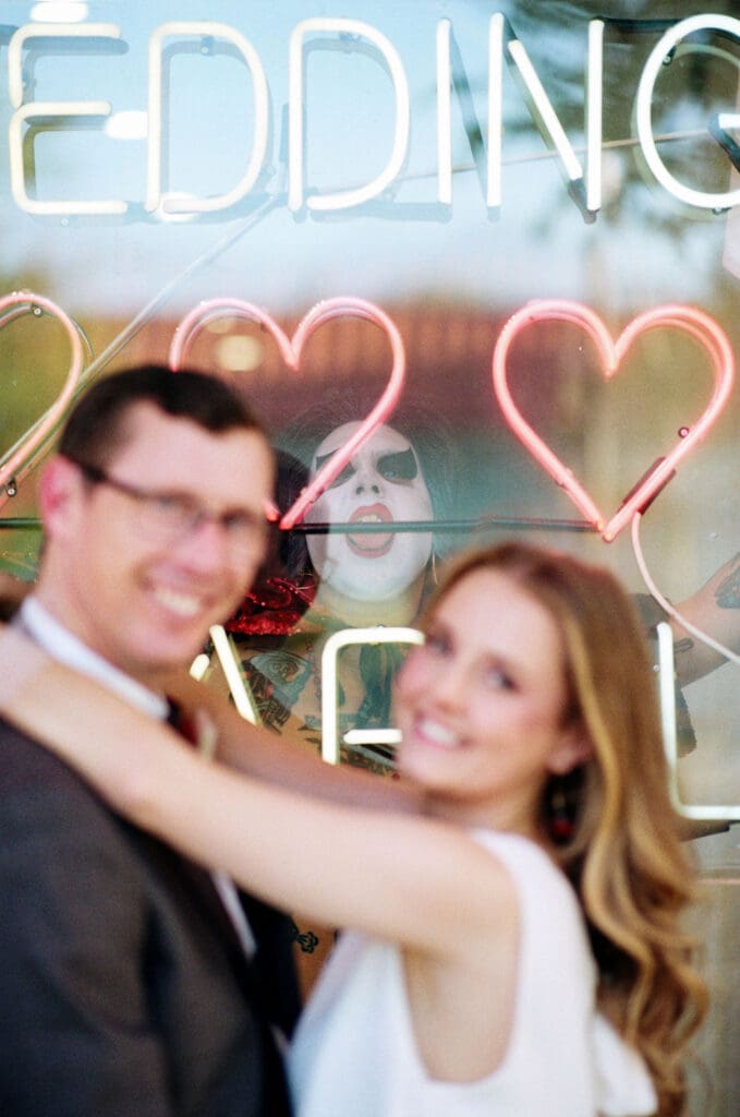 newlyweds smiling at the camera during their session